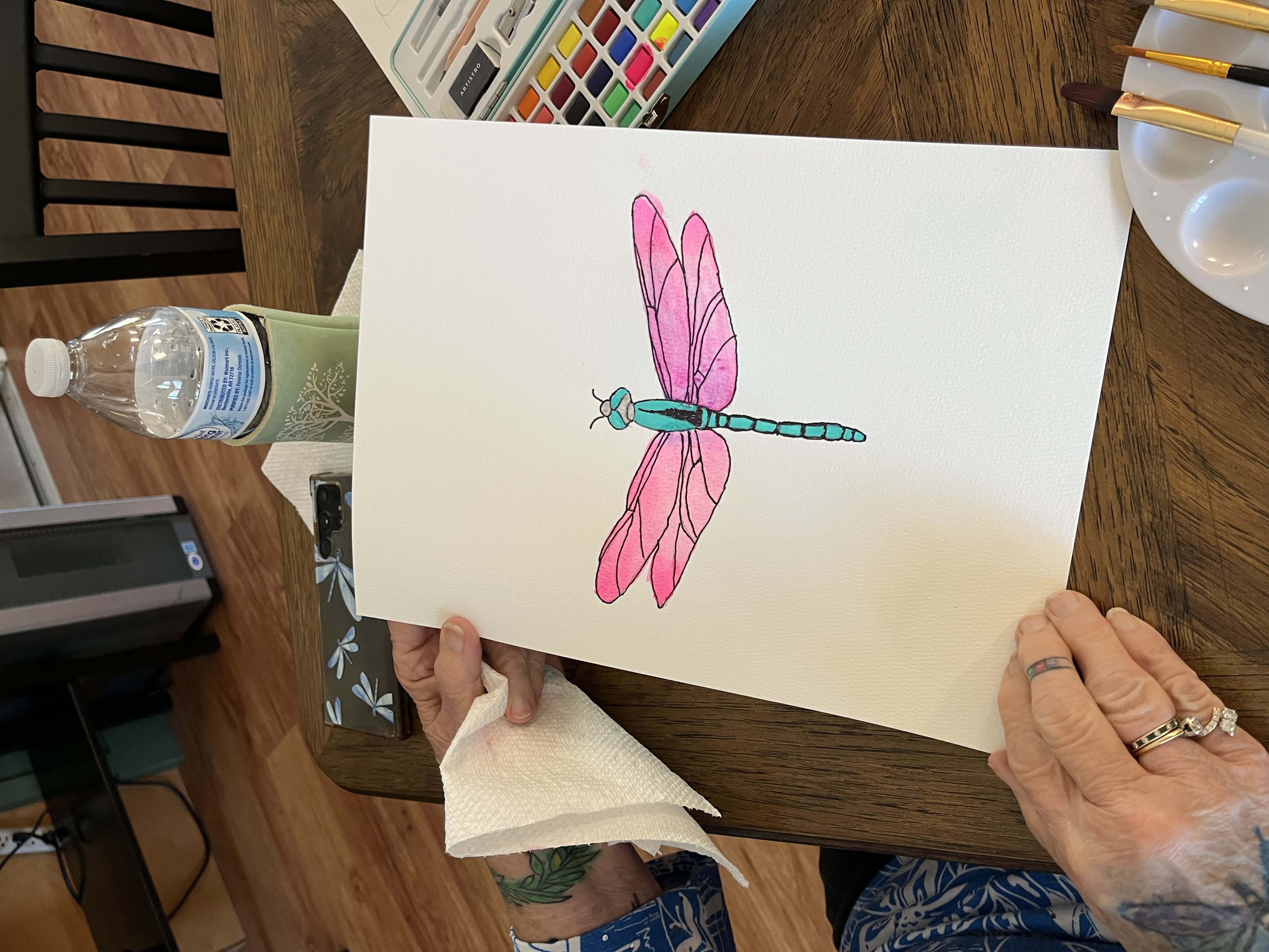 A watercolor dragonfly painting from a resident art class